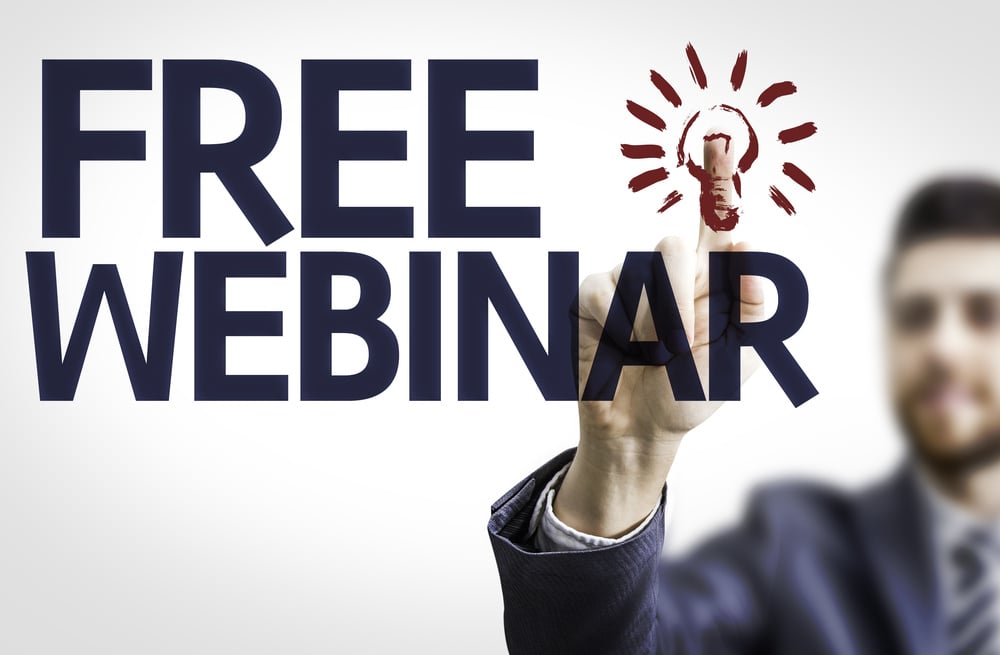 Business man pointing to transparent board with text Free Webinar Business man pointing to transparent board with text Free Webinar